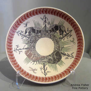 Sgraffito and painted wildlife, nature and geometric design on a polychrome plate