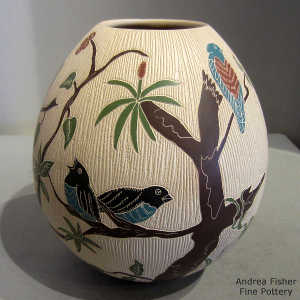 Sgraffito and painted bird and branch design on a polychrome jar