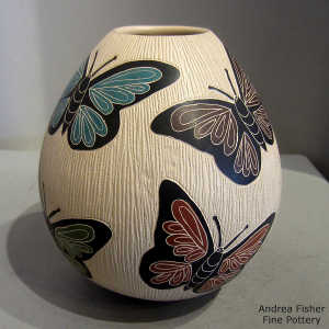 Sgraffito and painted butterfly motif on a polychrome jar