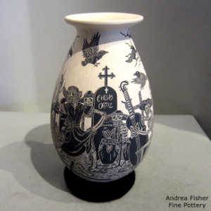 Sgraffito Day of the Dead motif ion a black and beige jar