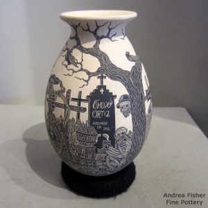 Sgraffito Day of the Dead motif on a black and beige jar