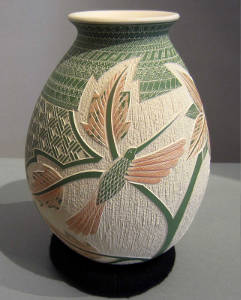 Sgraffito hummingbird, floral and Paquime geometric design on a polychrome jar