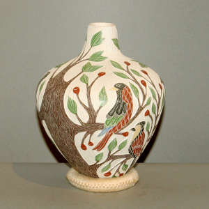 Sgraffito and painted bird, branch and flower design on a polychrome vase
