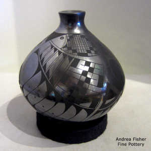 Fish and geometric design on a black on black jar