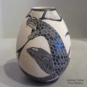 Sgraffito lizard and serpent design on a black and beige jar
