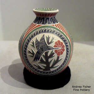 Lightly carved, sgraffito and painted hummingbird, floral and geometric design on a polychrome jar