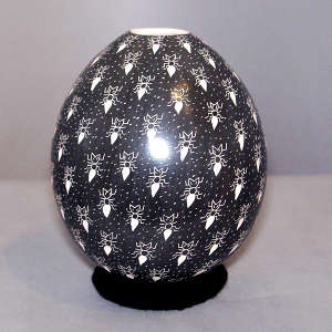 Sgraffito ant and background design on a black and white jar