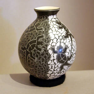 Sgraffito night-and-day lizard design on a black and white jar