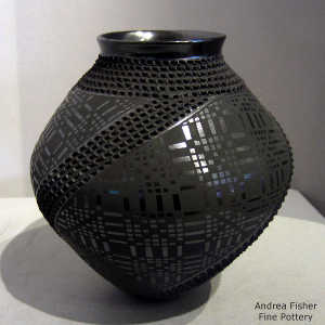 Textured surface and a geometric design on a black on black jar