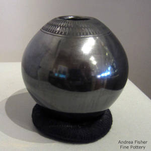 Feather and geometric design on a black on black jar