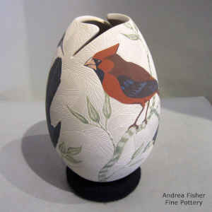 Sgraffito and painted bird, branch and geometric design on a polychrome jar with an organic cut opening