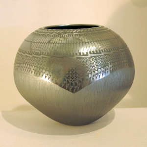 Painted sgraffito Paquime geometrics above and sgraffito striations below on a black on black jar