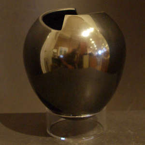 Irregular opening on a polished black vase