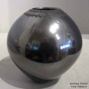 Matte black Paquime necklace on a polished black jar