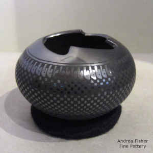 Black on black jar with a cuadrillos design and an organic opening