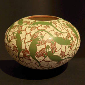 Sgraffito and painted brown and green lizard design on a beige jar