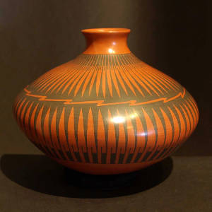 Paquime feather design painted on a red and black jar