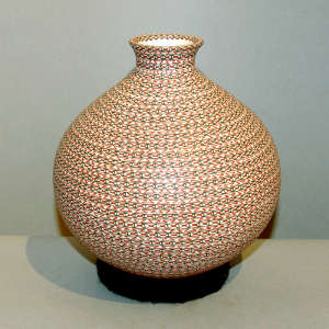 Bands of tiny geometrics on a thin neck polychrome jar