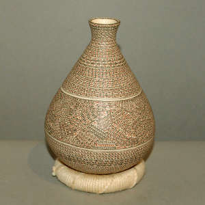Miniature geometric designs on a thin neck polychrome jar