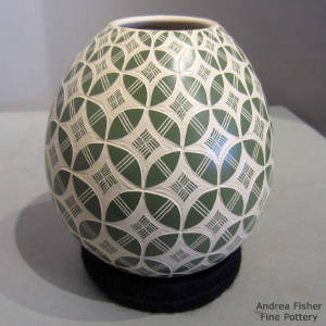 Green and white jar with sgraffito geometric design