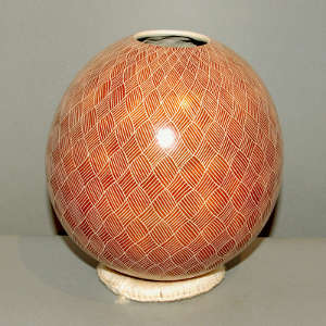 Geometric design on a red and white jar