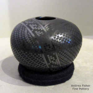 Black on black jar with a geometric design