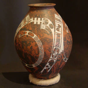 White Paquime designs on a brown and black marbled clay jar