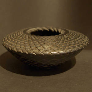 Corrugated opening on a tooled, black graphite flying saucer jar