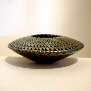 Textured surface on a black flying saucer jar