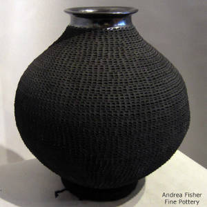 Corrugated design and polished rim on a black jar