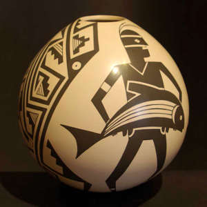 Dancer and geometric design on a brown on white jar