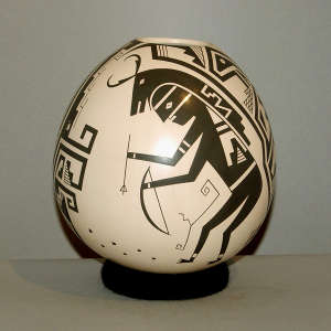Deer dancer and geometric design on a brown on white jar