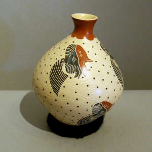 Lightly carved fish and geometric design on a polychrome vase
