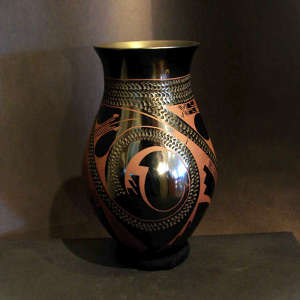 Incised and geometric design on a brown on black jar