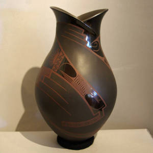 Geometric design and organic opening on a black on black on black vase