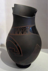 An organic opening and geometric design on a black on black on black vase