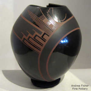 Organic opening on a black on black jar with a red geometric design