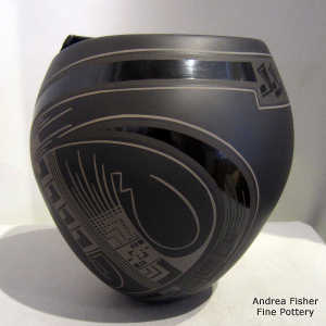 Geometric design on a black on black on black jar with an organic cut opening