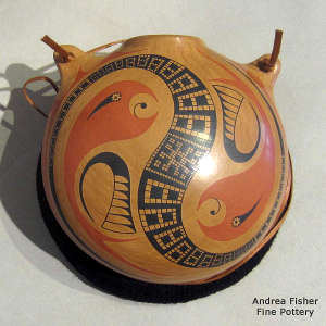 Stylized parrot and geometric design on a polychrome canteen