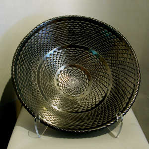 Corrugated surface inside and out on a large polished black bowl