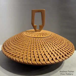 Corrugated surface on a lidded brown flying saucer jar