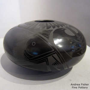 Bird, fish and geometric design on a black on black jar