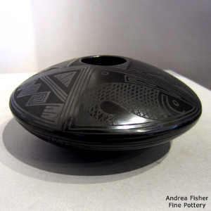 Fish and geometric design on a black on black jar