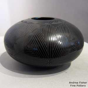 Fine line and geometric design on a black on black jar