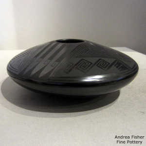 Bird, fish and geometric design on a black on black jar