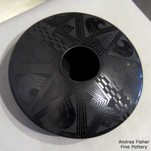 Bird element and geometric design on a black on black jar