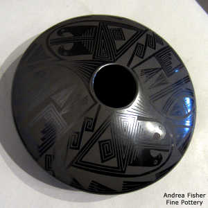 Bird element and geometric design on a black on black jar