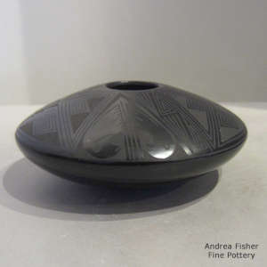 Bird element and geometric design on a black on black jar