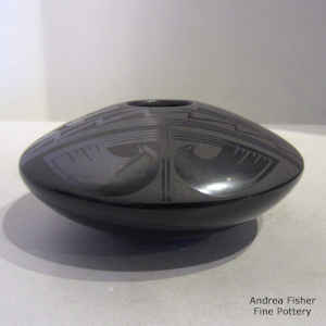 Bird element and geometric design on a black on black jar