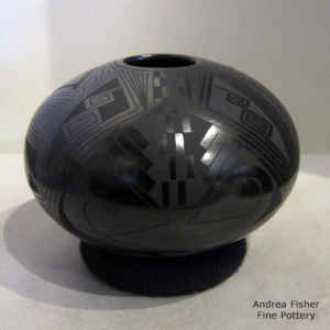 Bird element and geometric design on a black on black jar